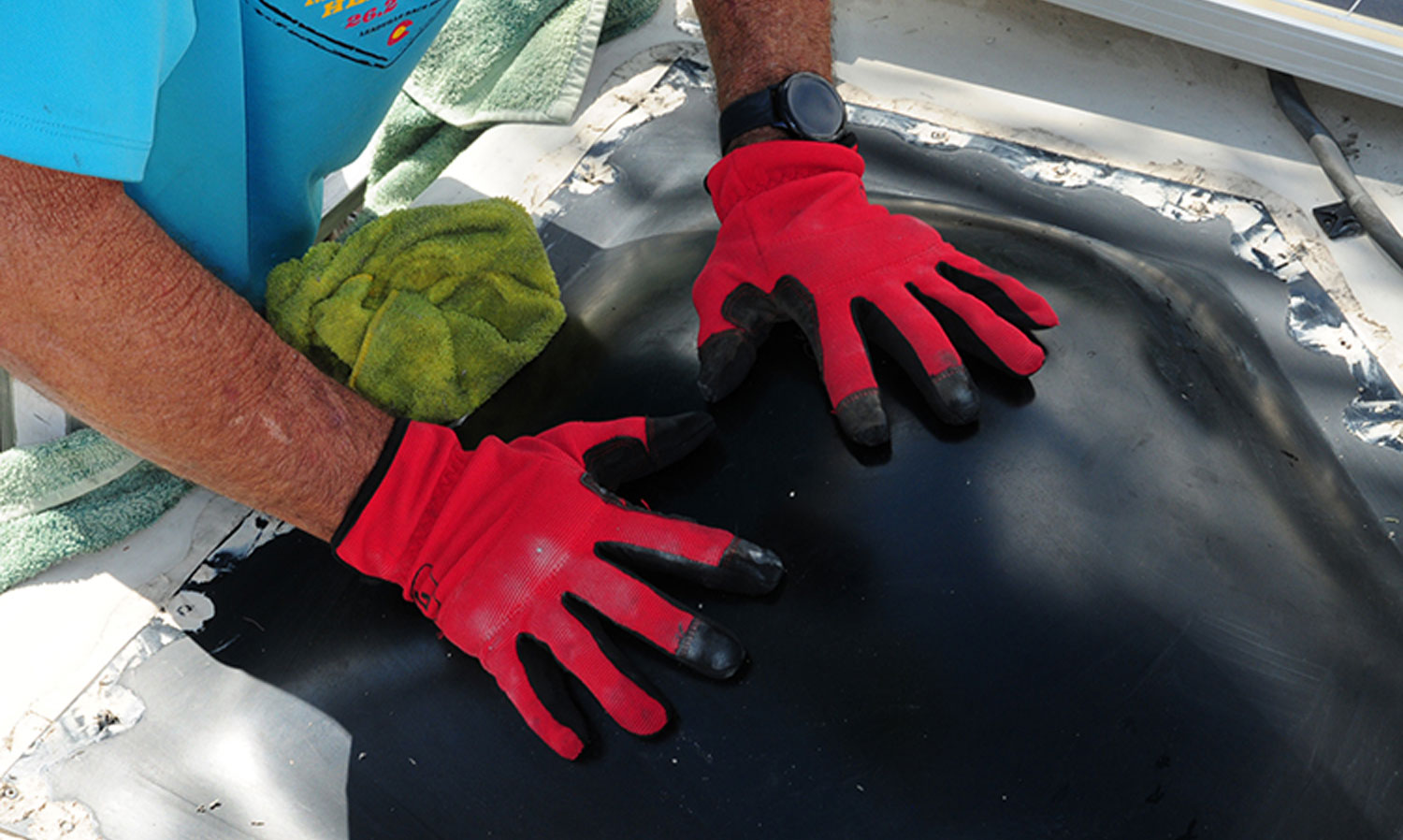mechanic places hands on the skylight in warning not to lean or rest on the piece