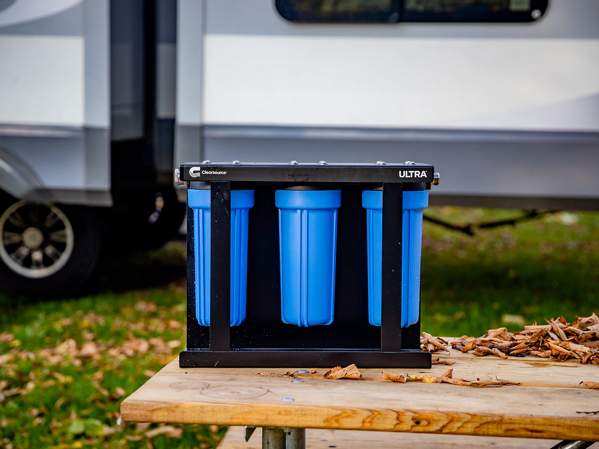 Clearsource Ultra water filter system on a bench table with an RV in the background