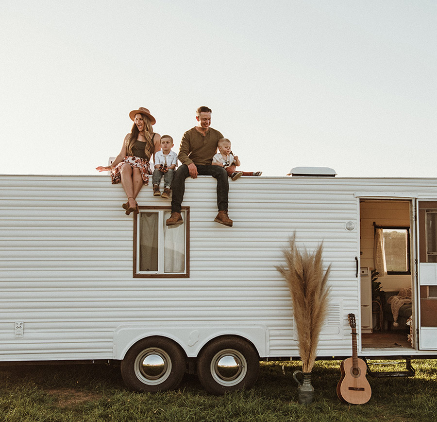 family sitting on top of an RV