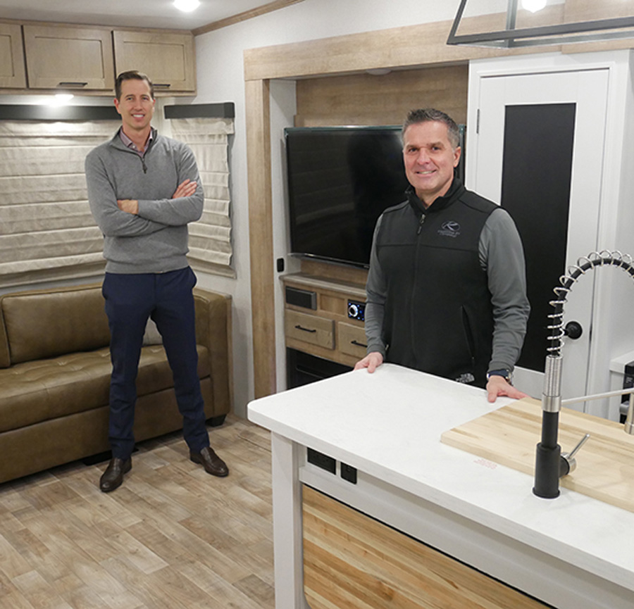 two men standing in an RV