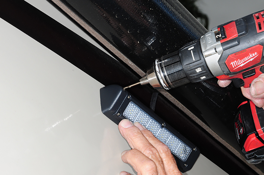 Pilot holes being drilled in the sidewall