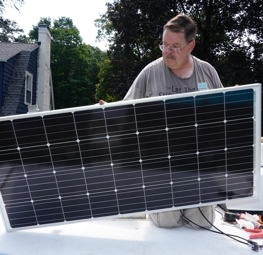 man installing solar in an RV