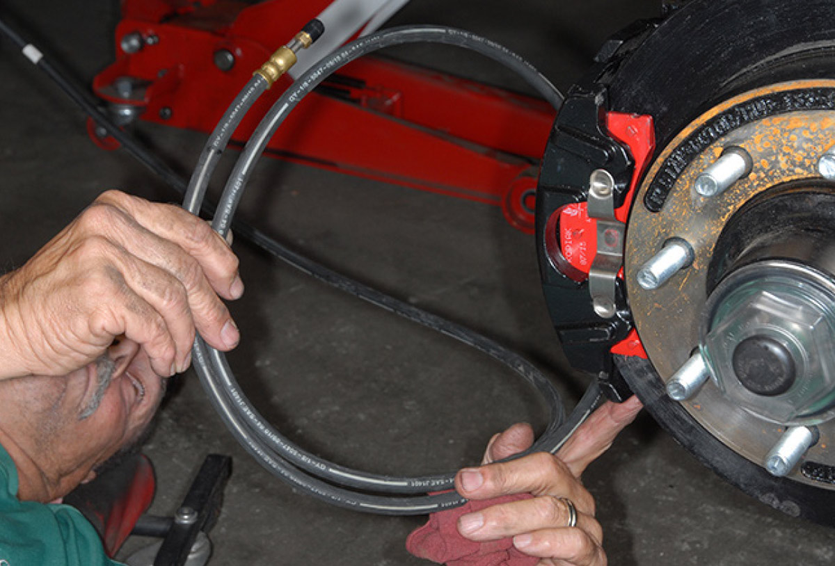 Hydraulic lines are routed from the actuator mounted in the front storage compartment to each wheel