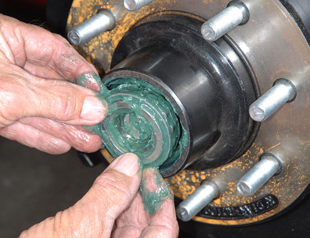 New bearings are packed with grease and installed in the rotor