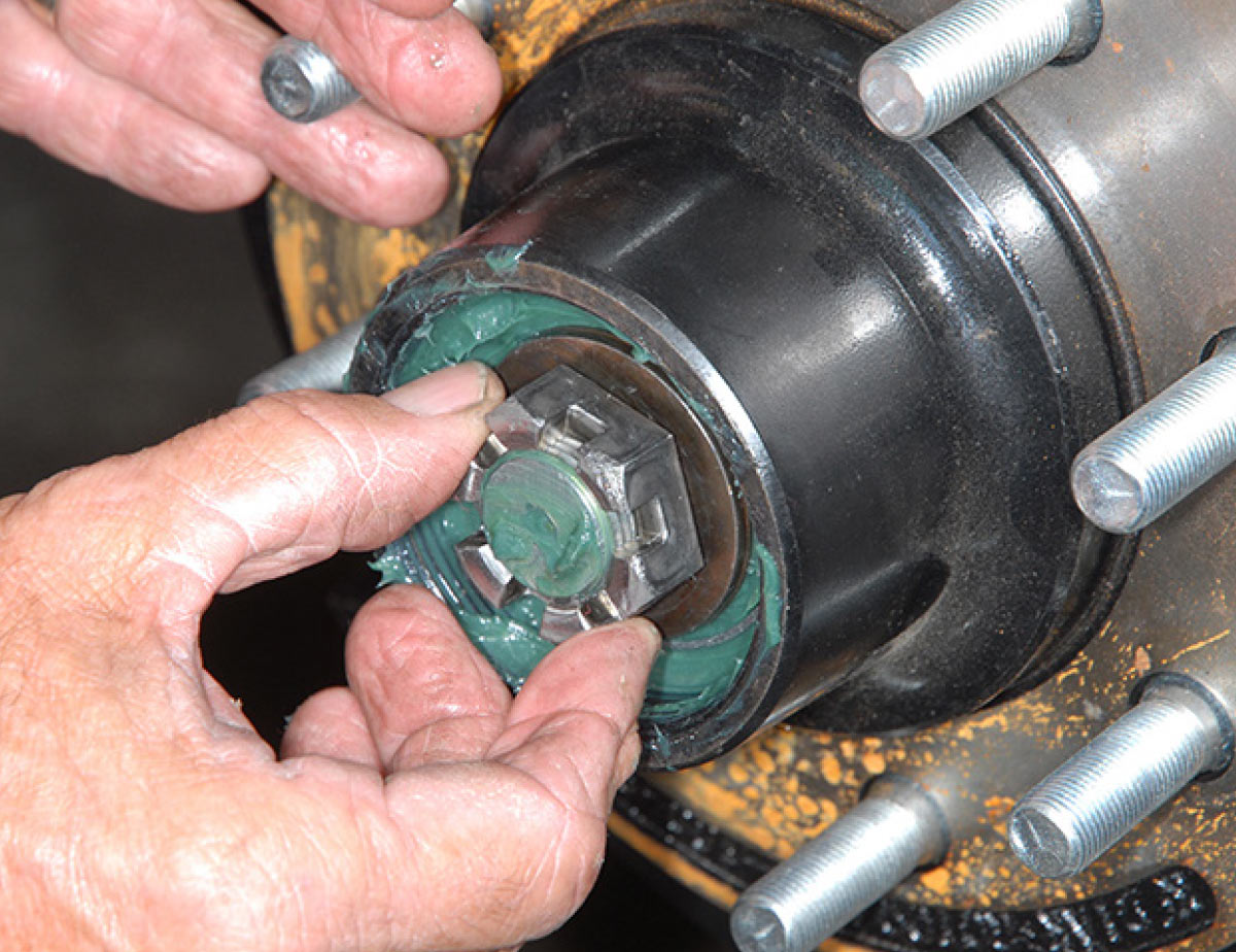 Re-install the washer and screw-on the castle nut