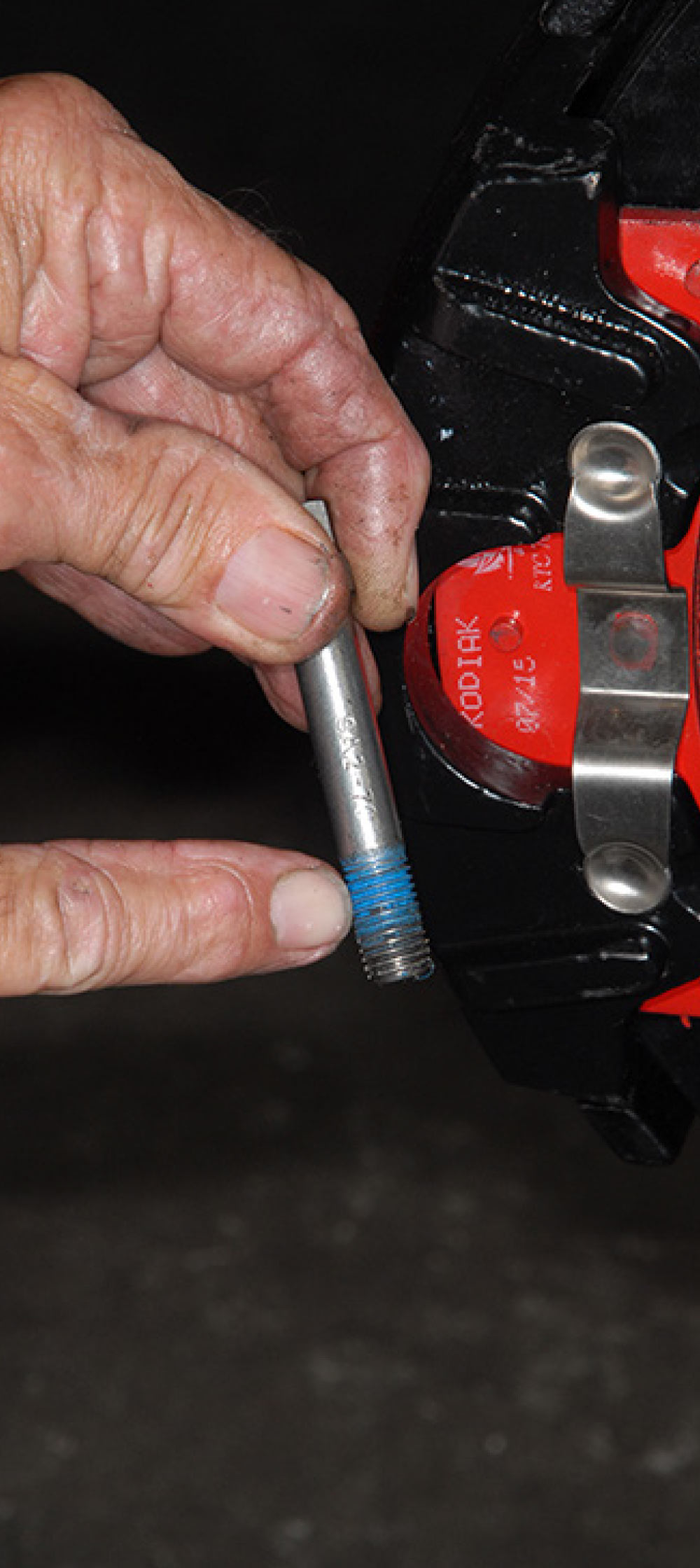 The hold down bolt is coated with blue thread sealer