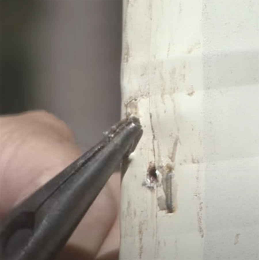 rusty or damaged staples being removed and replaced