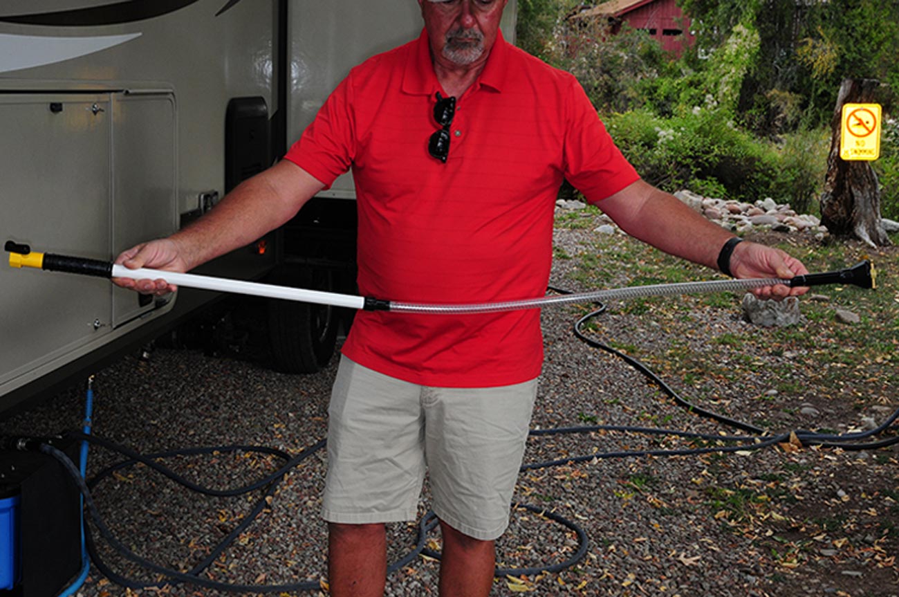 RV owner holds the Swivel Stik to show it length