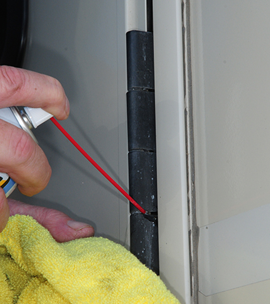 closeup of Blaster Dry Lube with Teflon being used on latch