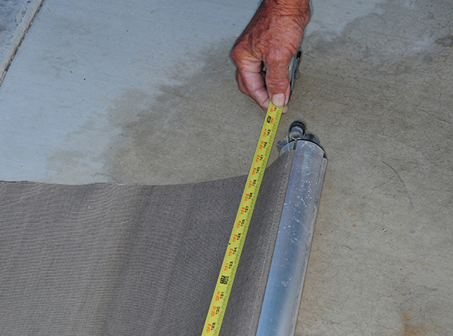 the width of the slide-out and length of the fabric next to a measuring tape