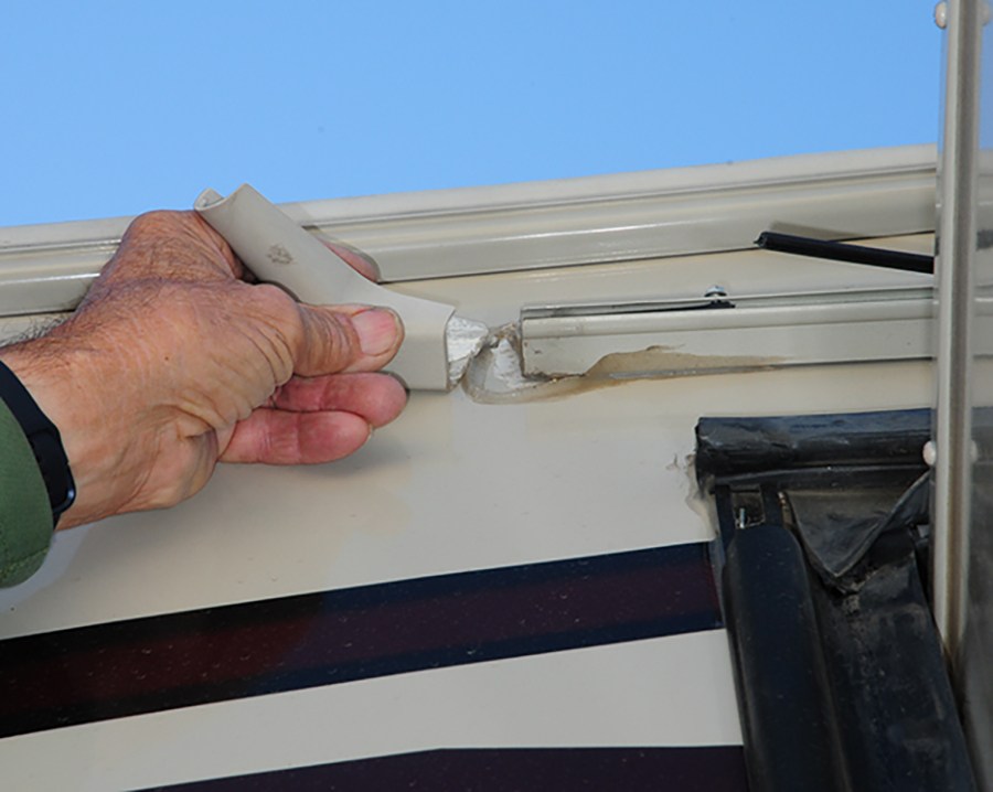 gutter spout on the end of the awning rail