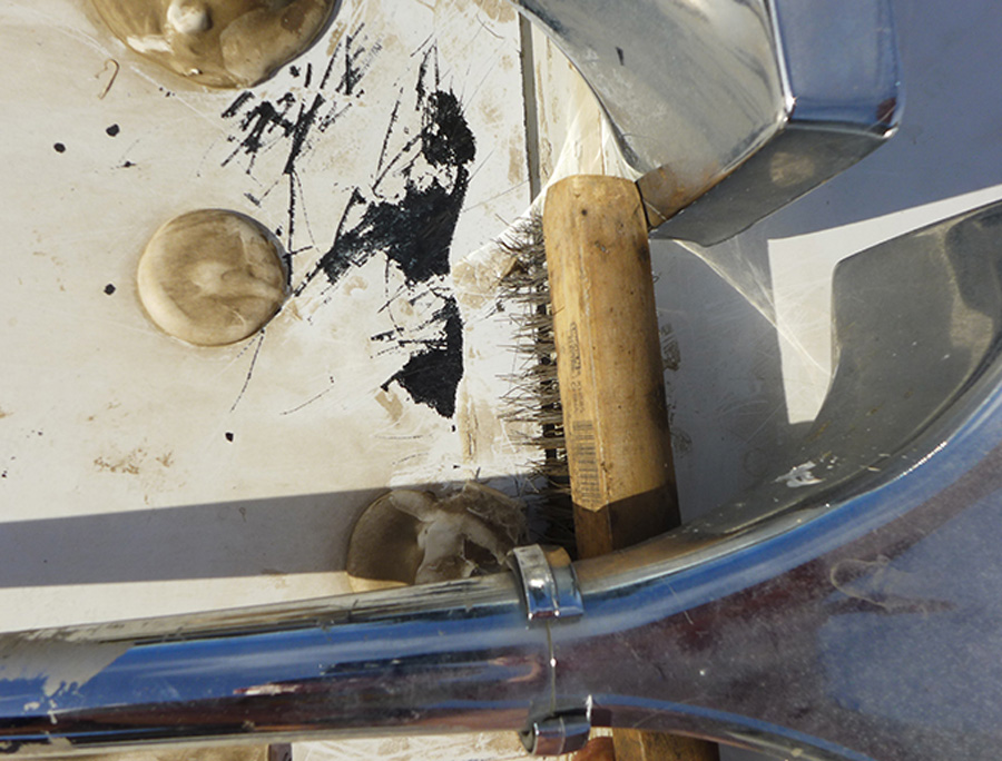 A wire brush may be necessary to remove excess sealant (not able to scrape off) when working around obstacles on the roof
