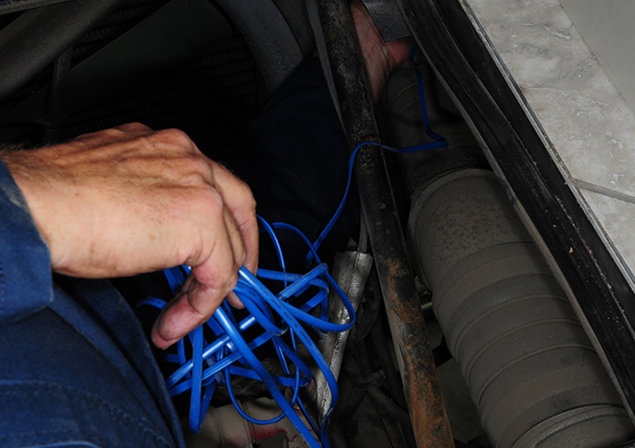 routing the cable from the new battery temperature sensor into the compartment
