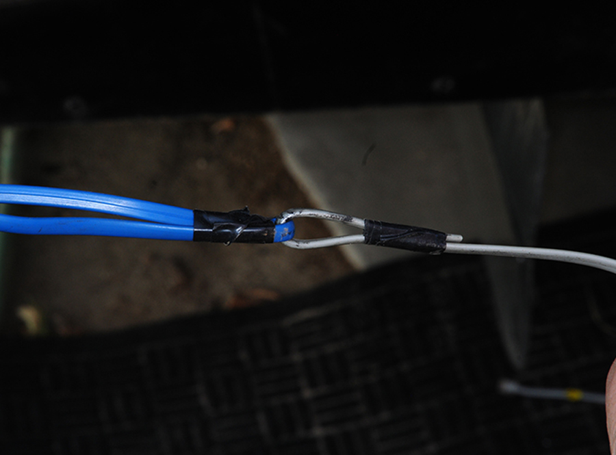 Most of the old sensor cable was cut away, but one end was used as a fish wire to find a suitable pathway to the compartment where the inverter/charger is mounted