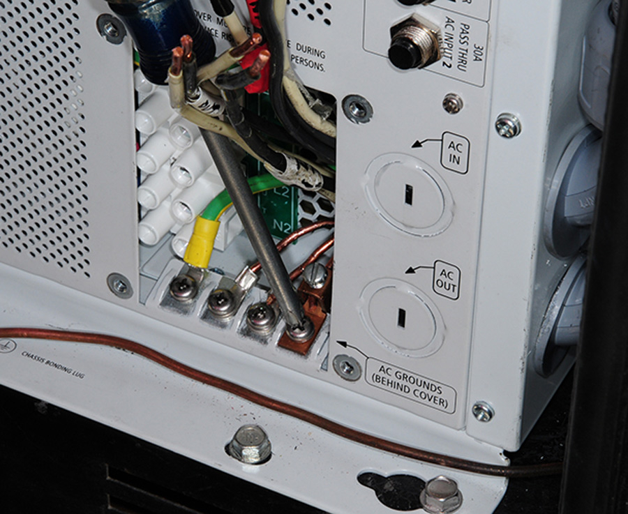 Terminals were crimped to the ground wires and attached to the bus in the bottom of the wiring access area