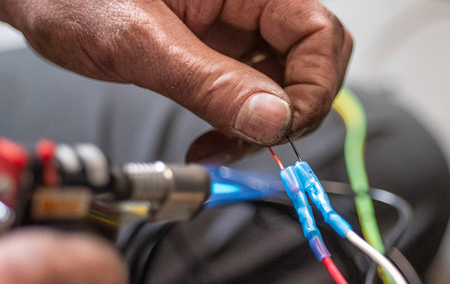 mechanic uses heat-shrink connectors on wiring exposed to the elements