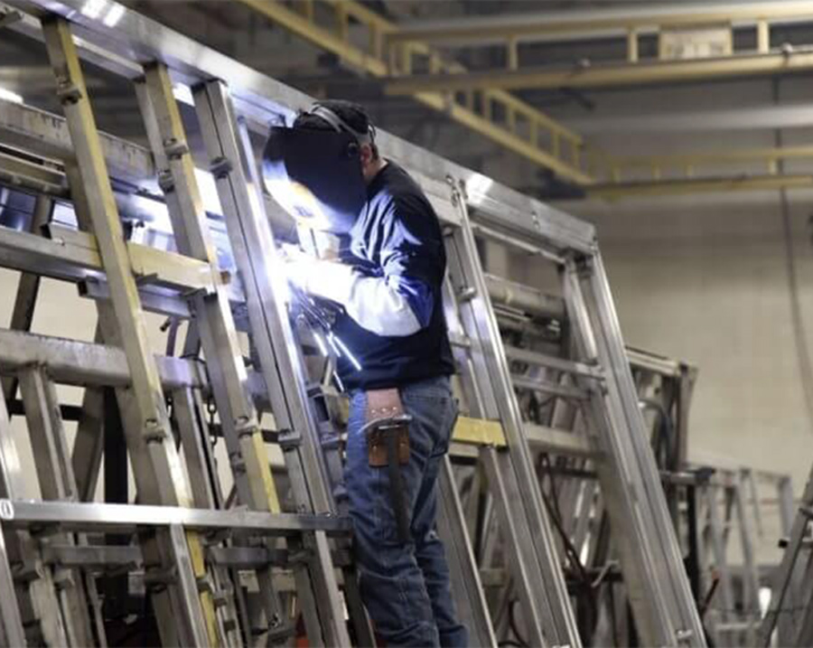 American Coach factory worker welding