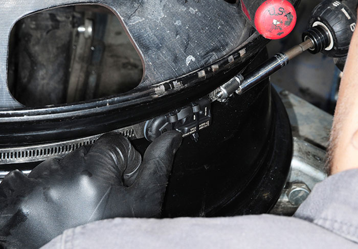 The band was tightened around the wheel and the end cut with hand snips (not shown) to make a tidy installation