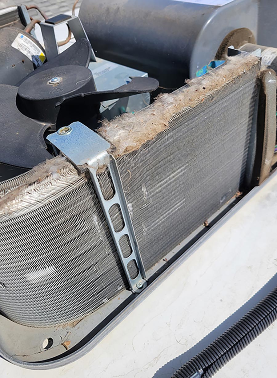 The design of this particular shroud allows the top of the condenser to collect excess dirt and debris, which must be cleaned off