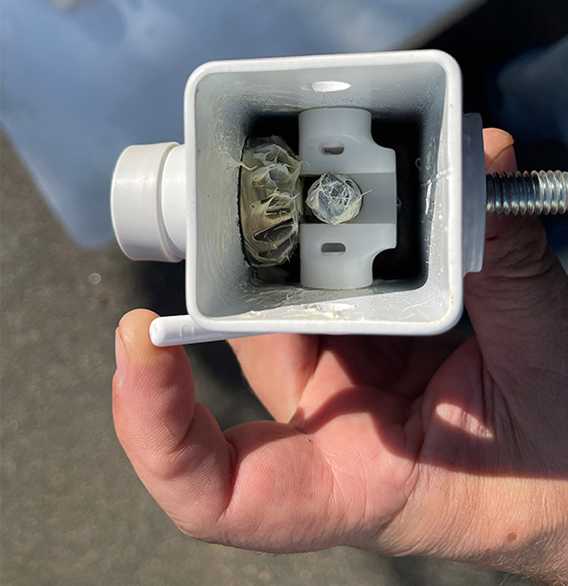 mechanic holds the Happijac quick drop lever part in hand