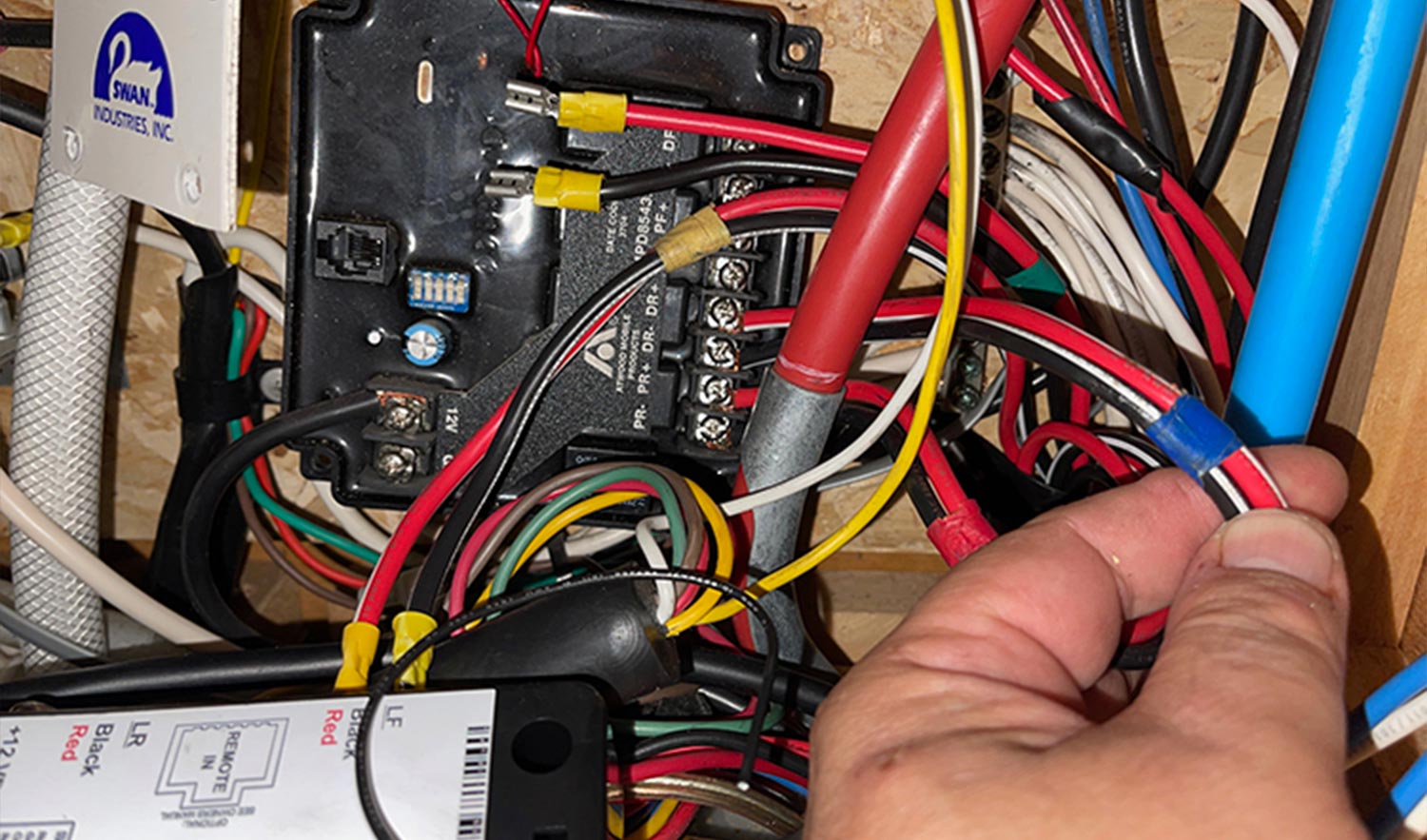 mechanic removes the wiring from the old jack remote reciever
