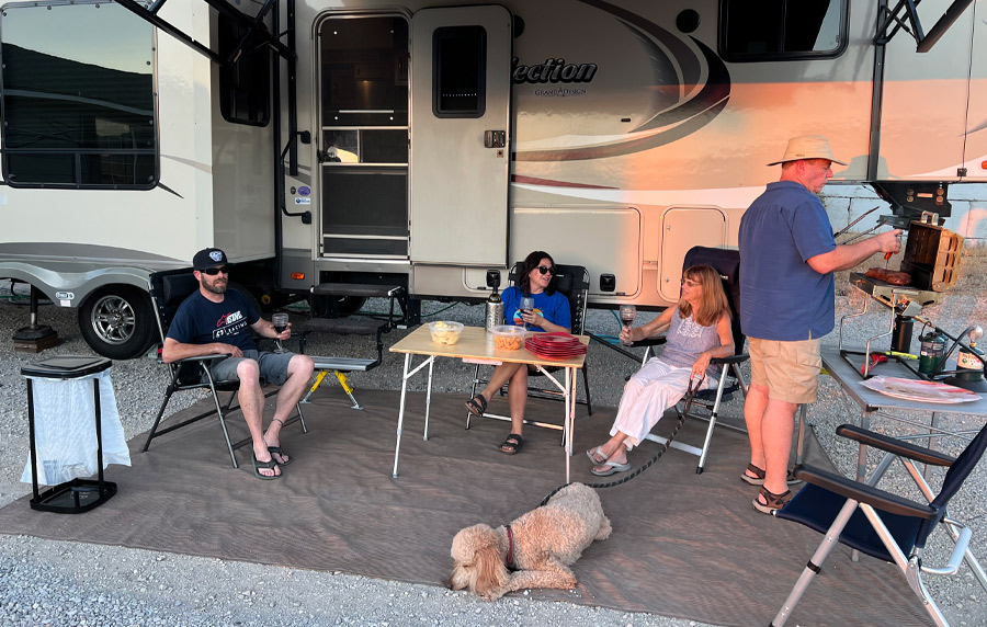 group of people having a barbecue outside their RV