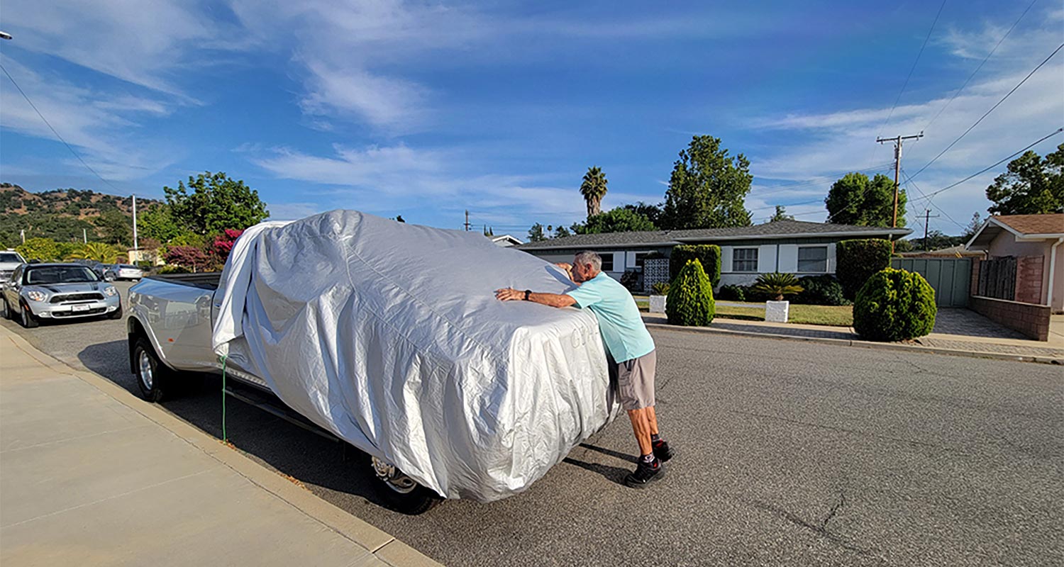 Man putting cover on pickup