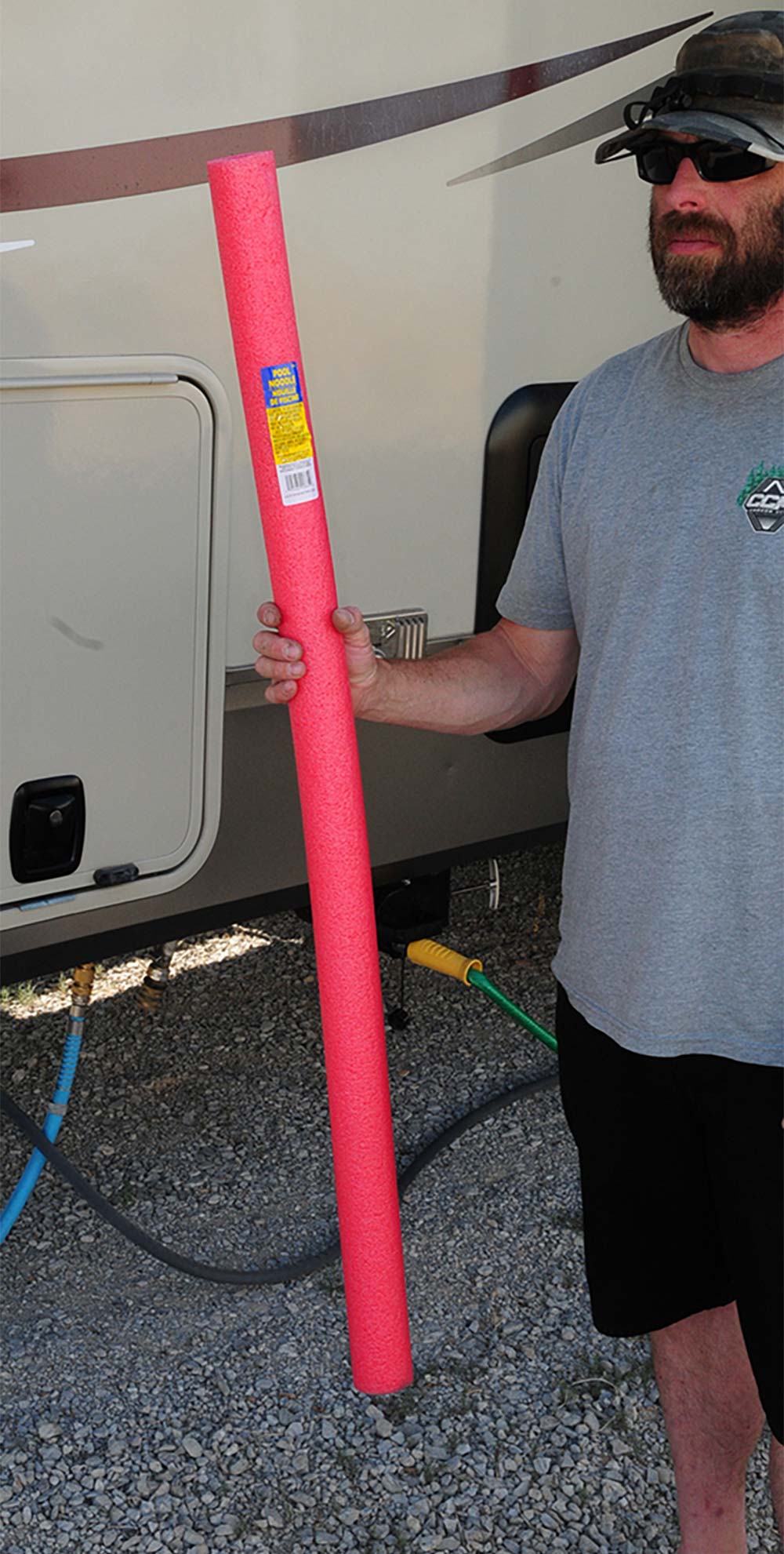 Man holding pool noodle
