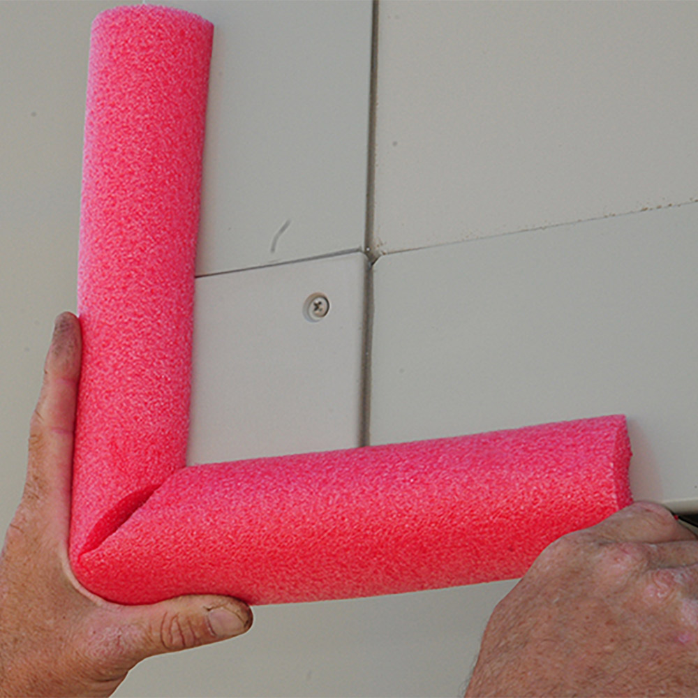 Test fitting split and cut pool noodle over RV slideout corner