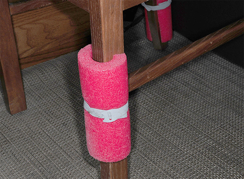 Pool noodle wrapped around dinner chair leg