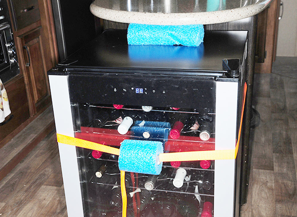 Small piece of pool noodle used to secure wine cooler doors from shaking