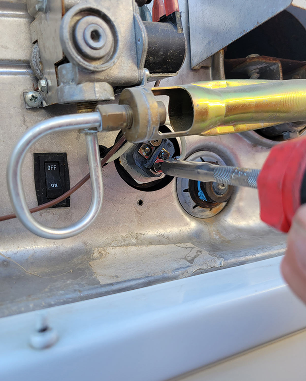 a screw on the heating element is loosened to remove a wire