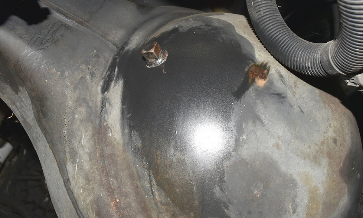 Completely removing the already loose fill hole plug