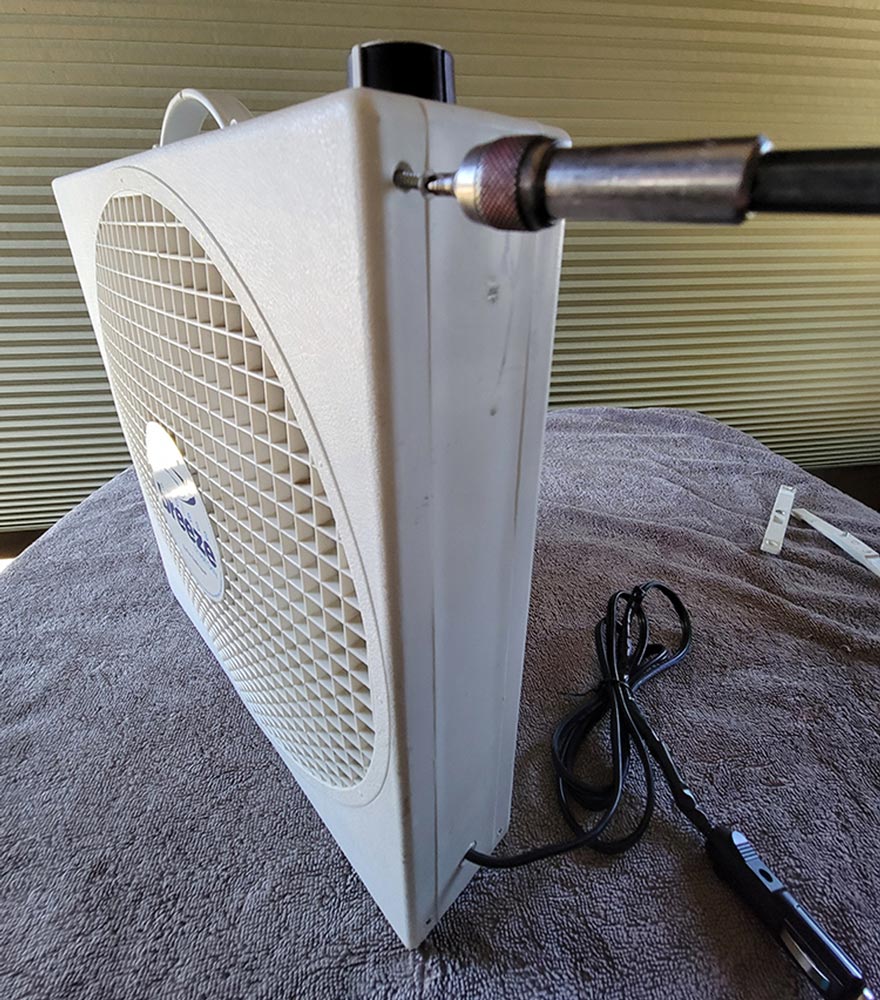 a screw is removed from an upper corner of the Endless Breeze fan