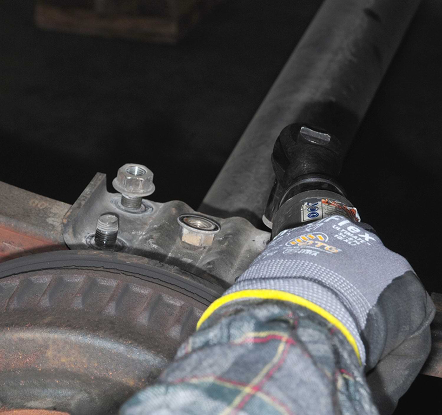 a drill is used to loosen the bolts on the original tie plate