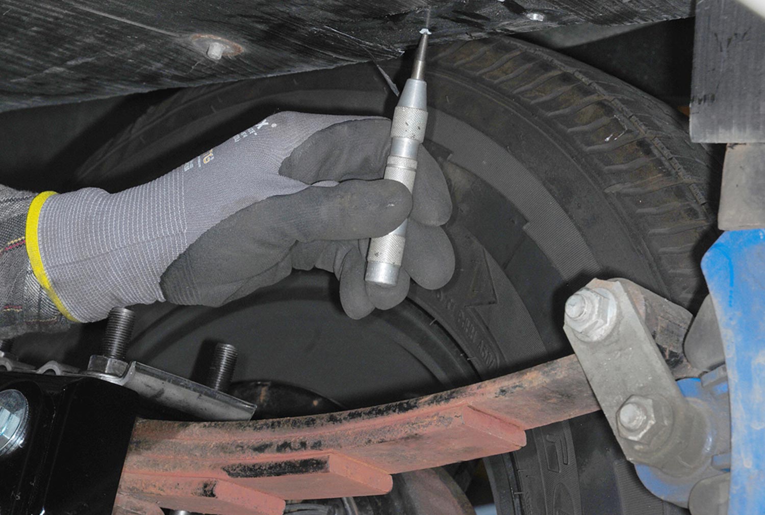 an area is marked in preparation for bolting the shock brackets in place
