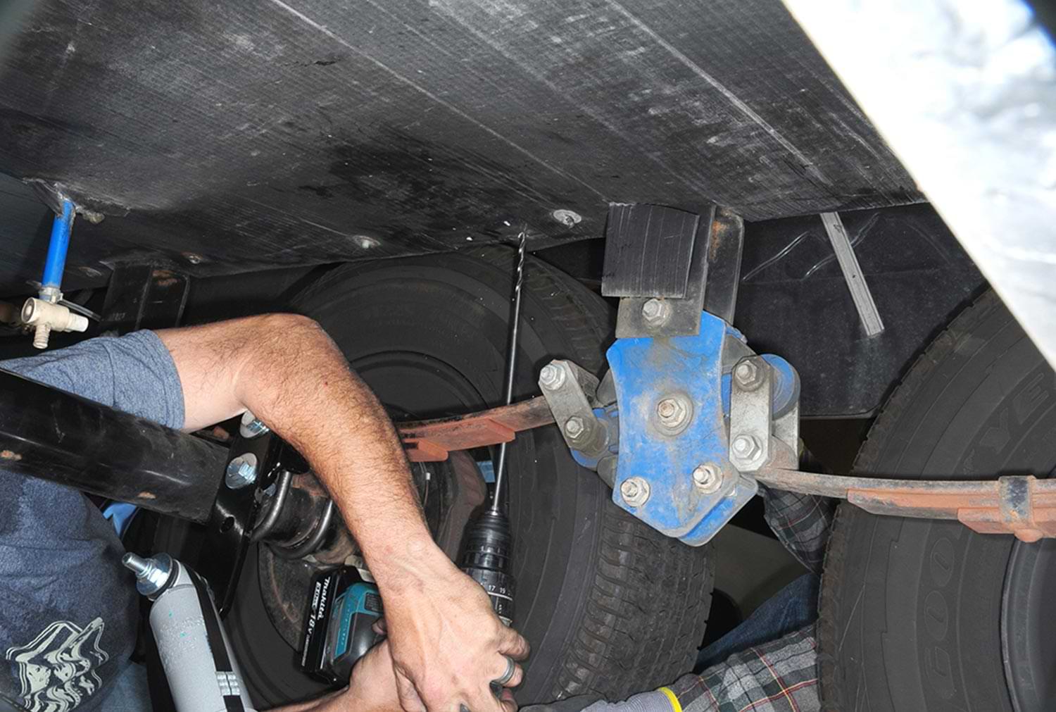 a drill is used to create a hole in the frame