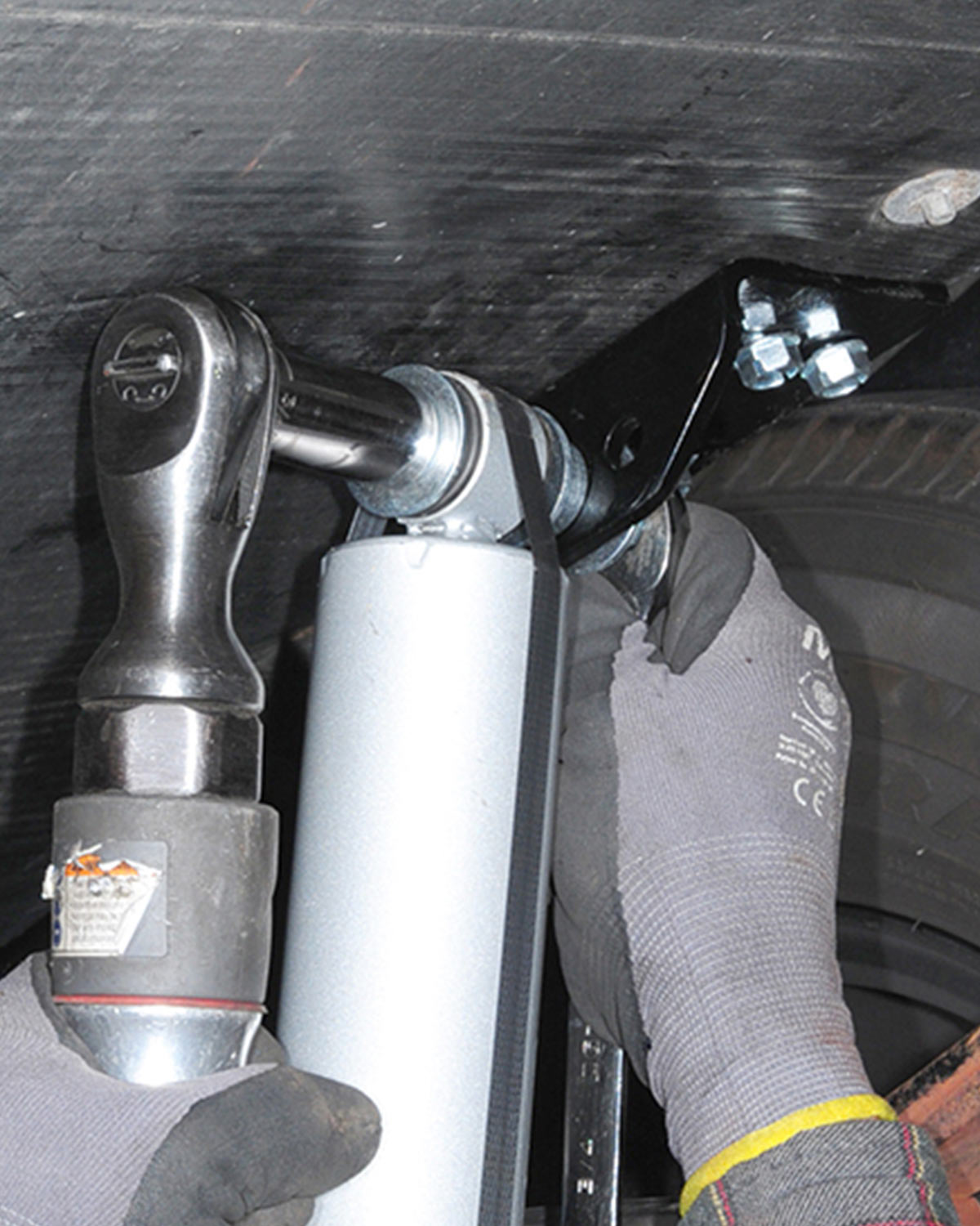 a bolt is tightened on the top end of a shock