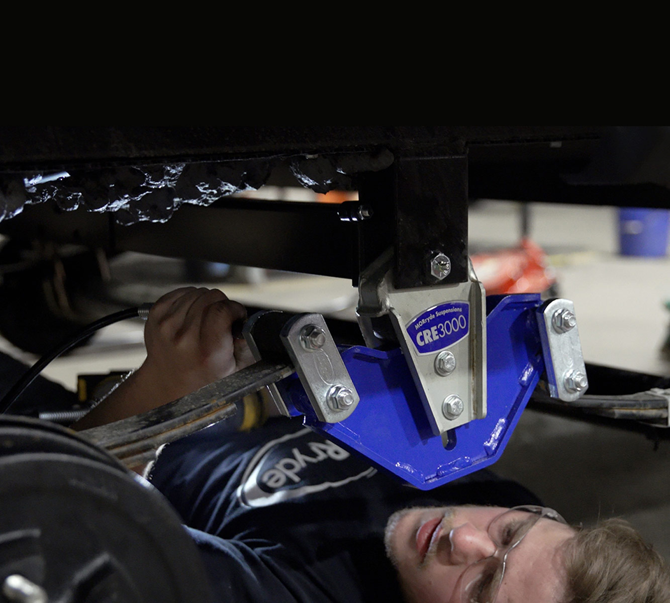 mechanic works on the bolts of the now installed CRE3000 system