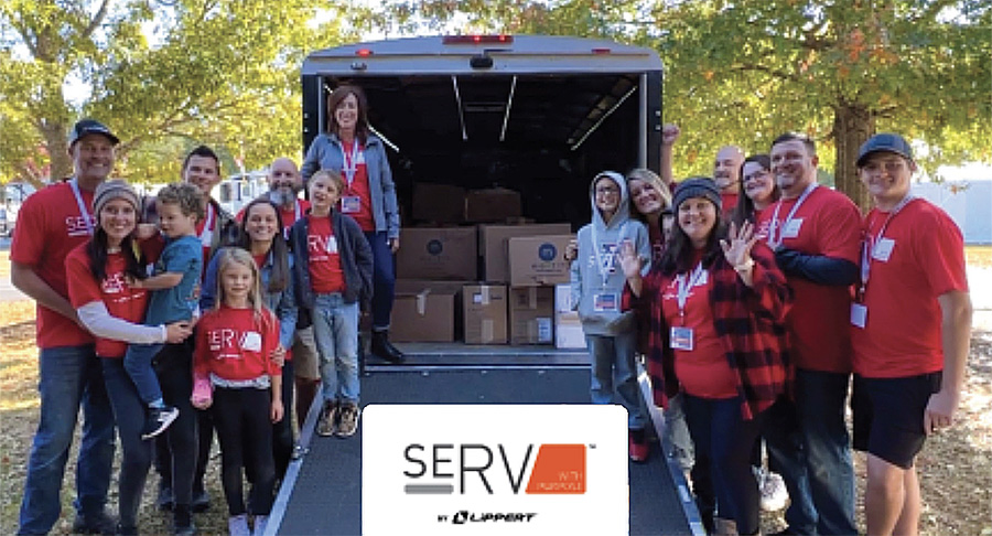 A group photograph of Lippert seRV volunteers smile and pose for a picture together outside