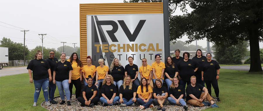 A group photograph of RV Tech Institute (RVTI) students smiling and posing for a picture together outside in front of the institute sign