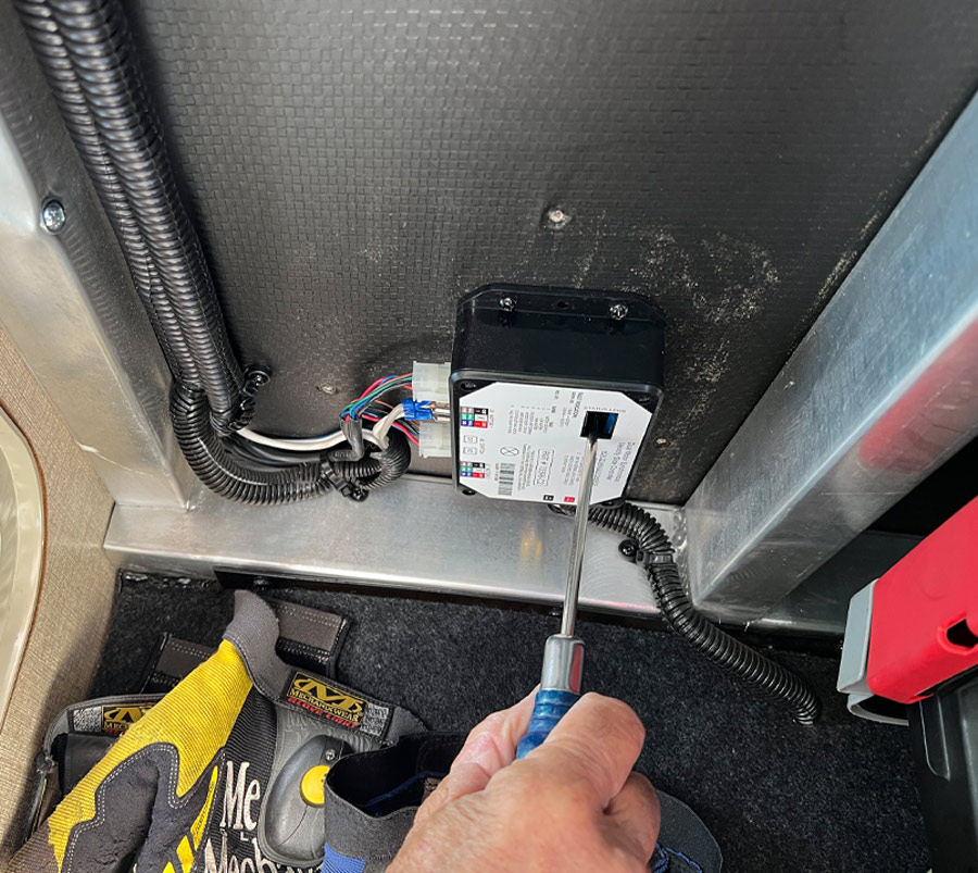 hand using a screwdriver on an electrical box