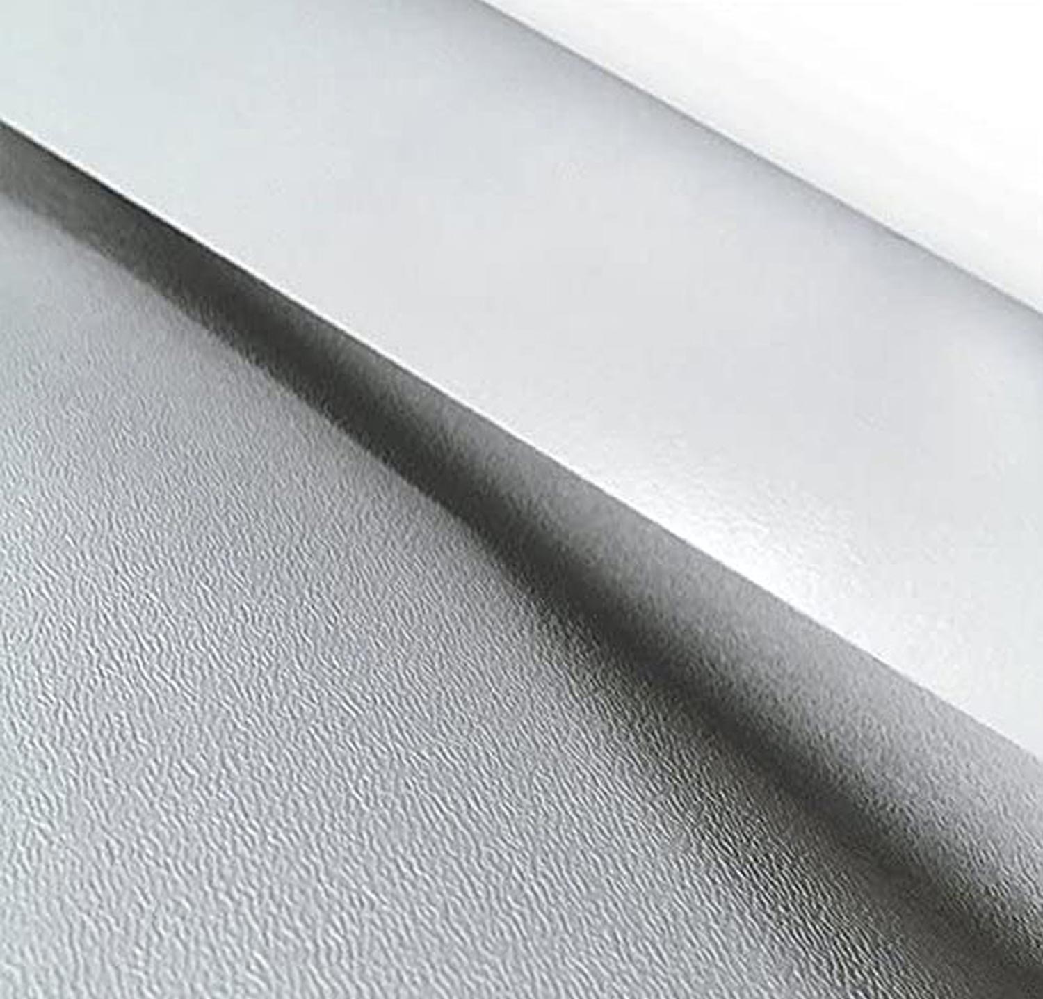 close up of a Alpha Systems Superflex TPO sample, one end slightly rolled to reveal the back of the material