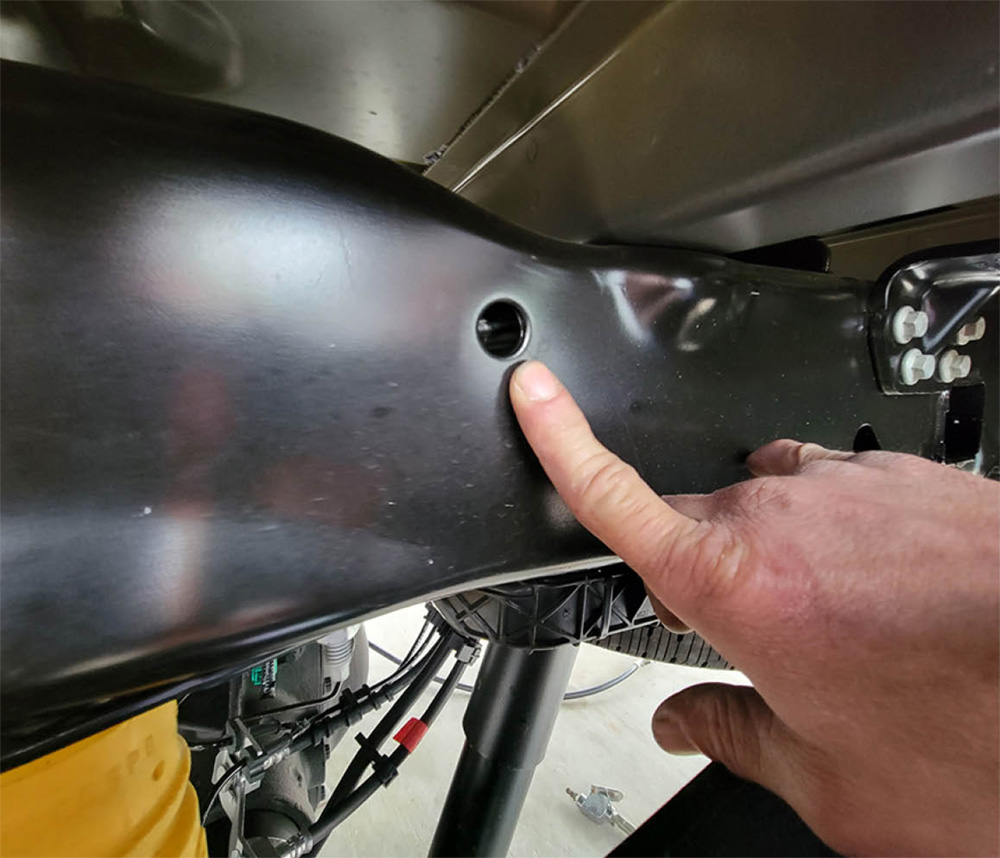 Hole in frame for hitch bolts