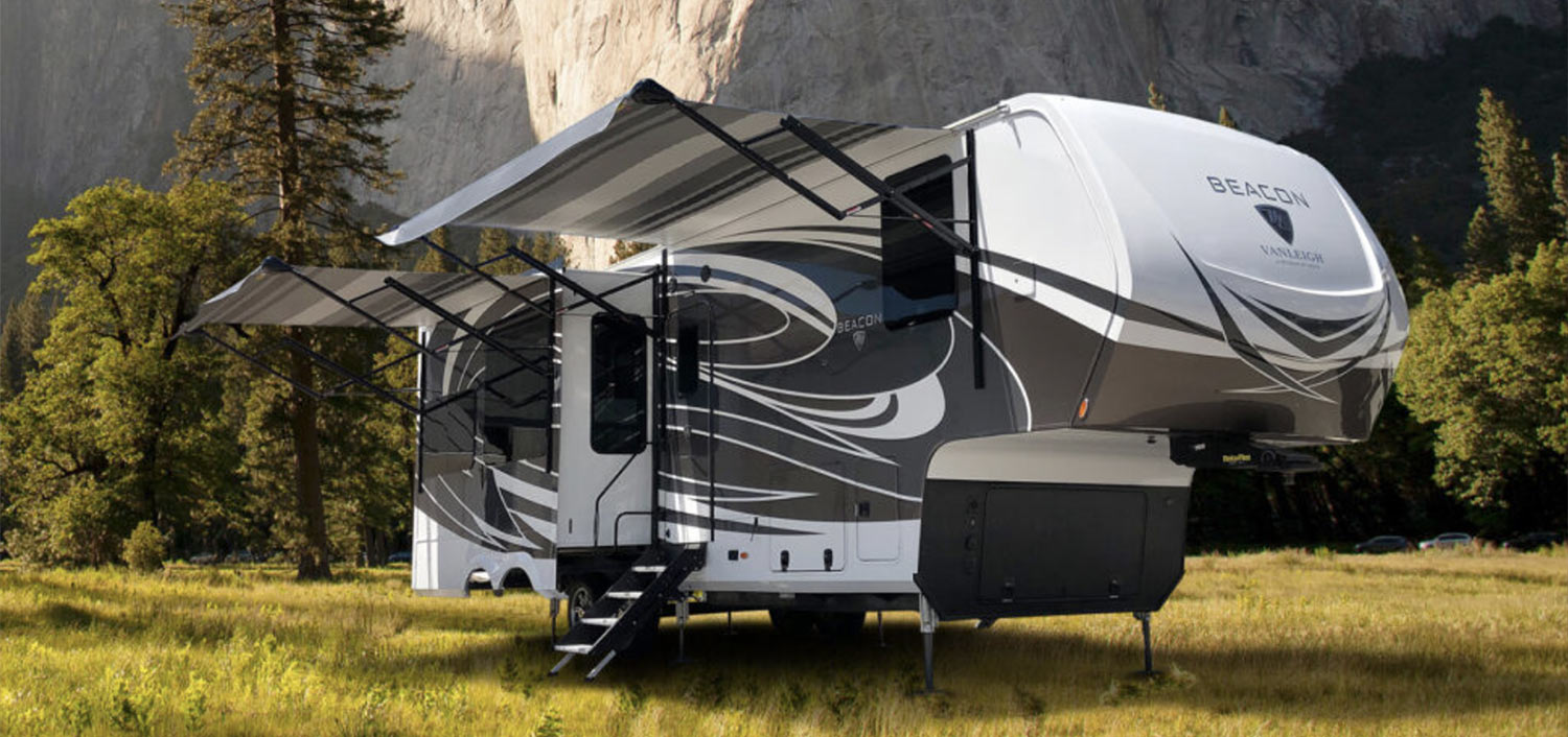 a trailer making camp in a wooded area