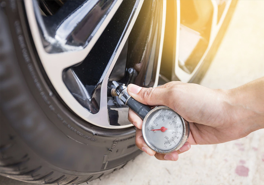 Checking tire pressure with gauge