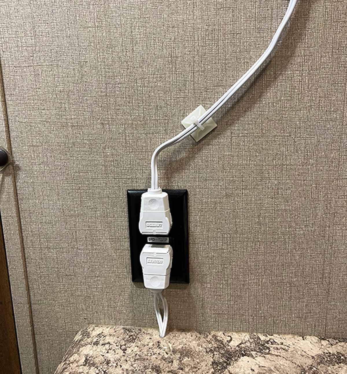 two wires plugged into an outlet