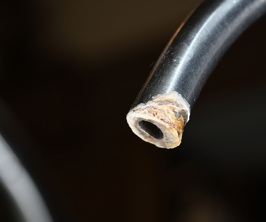 Before — The spray head on the kitchen faucet and the purified-water spigot were caked with calcium that not only looked ugly but impeded water flow. Hard water in RV parks — especially in the desert regions of the Southwest — wreaked havoc on the faucets in the kitchen and bathroom.