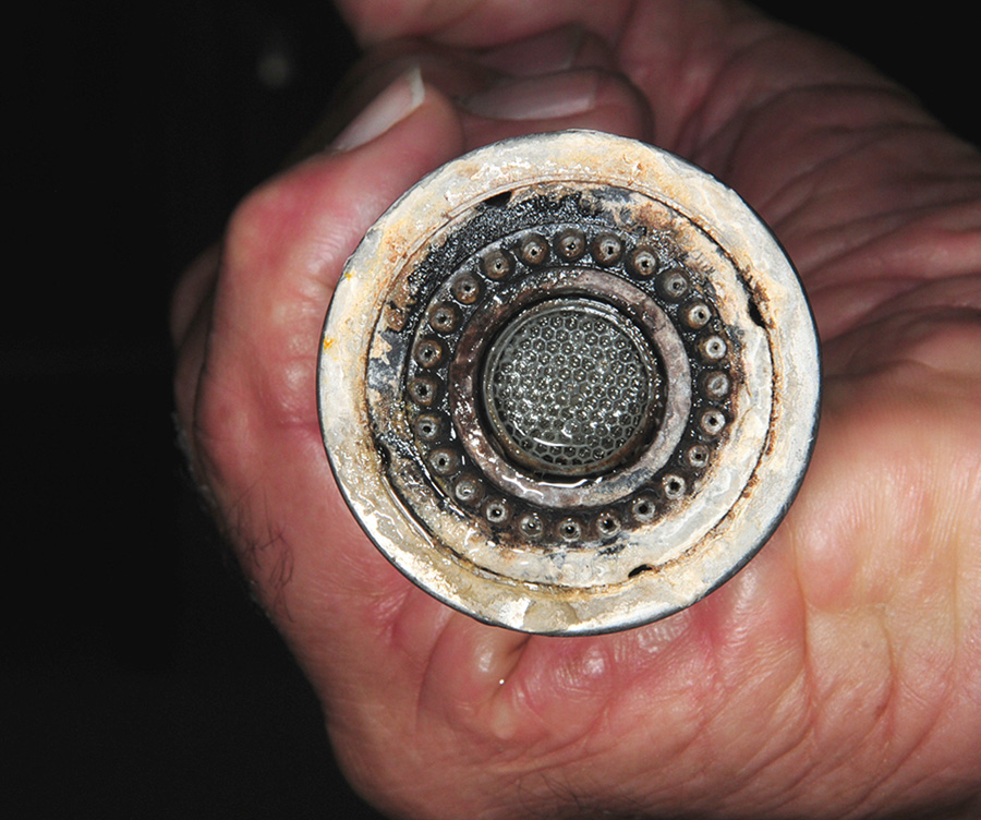Before — The spray head on the kitchen faucet and the purified-water spigot were caked with calcium that not only looked ugly but impeded water flow. Hard water in RV parks — especially in the desert regions of the Southwest — wreaked havoc on the faucets in the kitchen and bathroom.