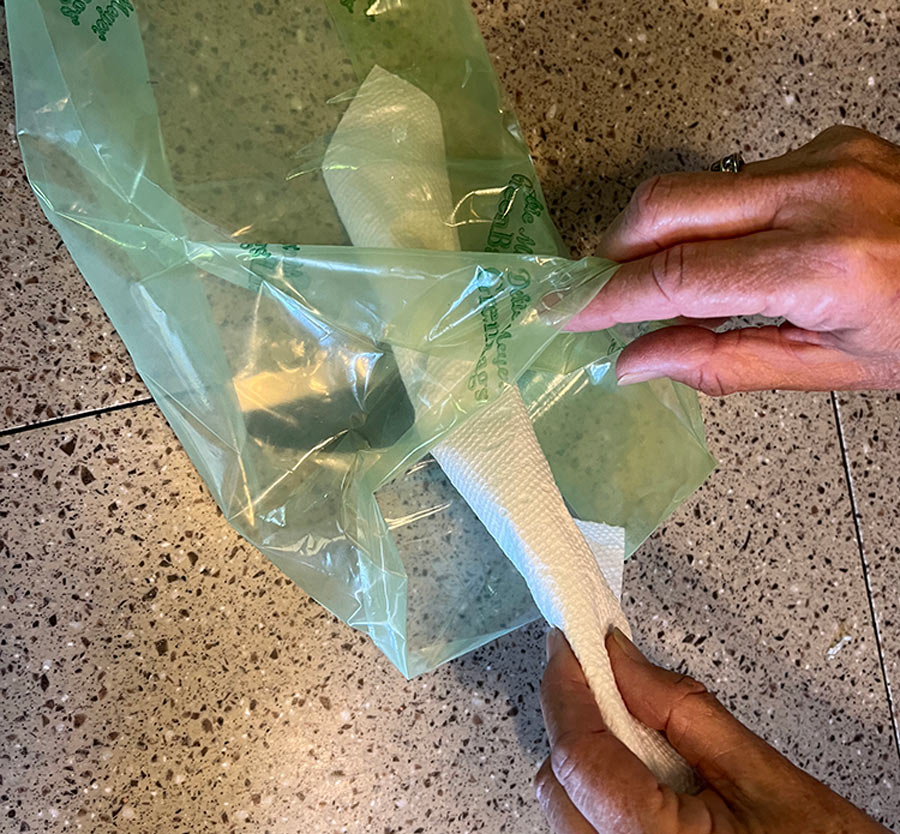 paper towels are wrapped over food and placed into green bag